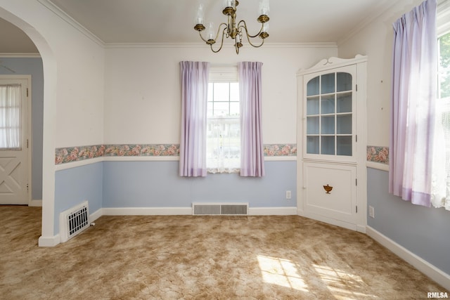 unfurnished dining area featuring carpet floors, crown molding, and a healthy amount of sunlight