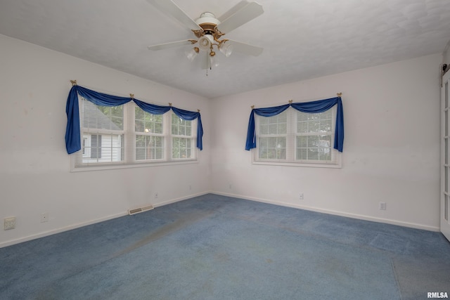 carpeted empty room featuring ceiling fan