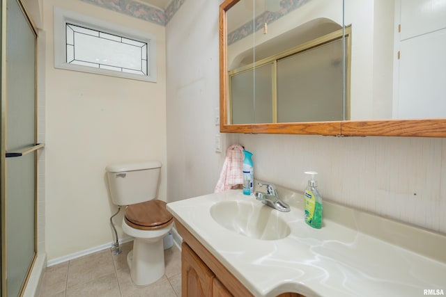 bathroom with walk in shower, tile patterned floors, vanity, and toilet