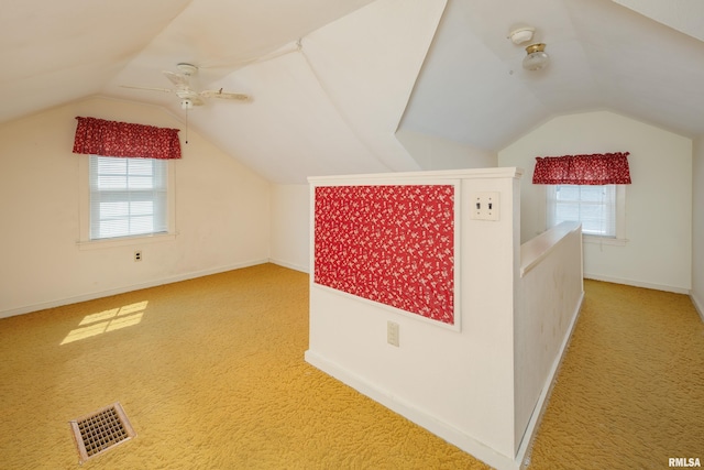 bonus room featuring a wealth of natural light, carpet floors, lofted ceiling, and ceiling fan