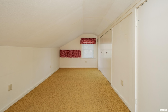 bonus room with light carpet and lofted ceiling