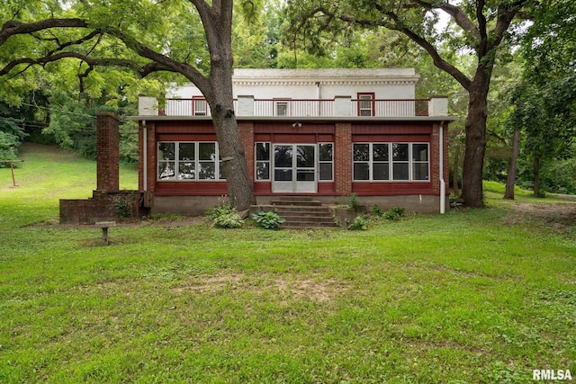 rear view of property with a yard