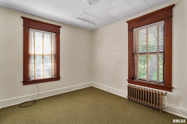 carpeted spare room featuring radiator