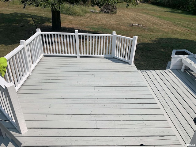 wooden deck featuring a yard