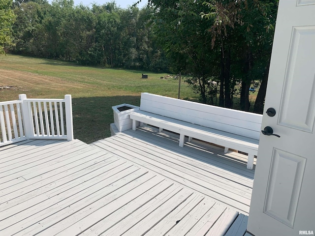 wooden deck featuring a yard