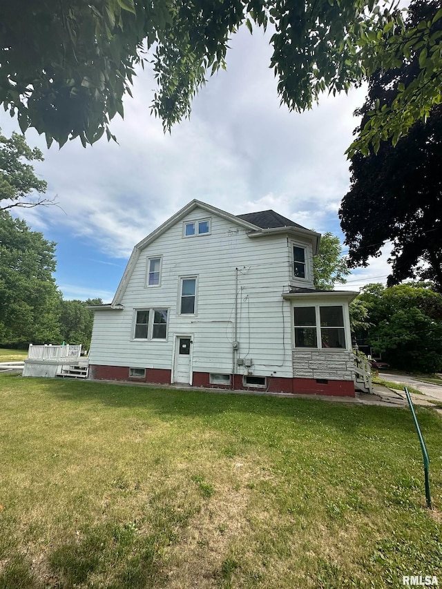 back of property with a lawn and a gambrel roof