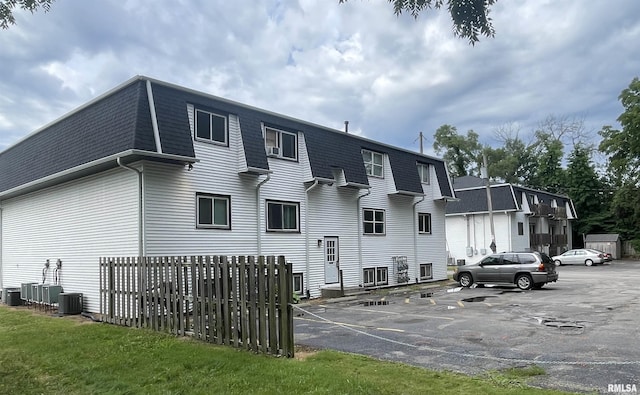 rear view of property featuring central AC