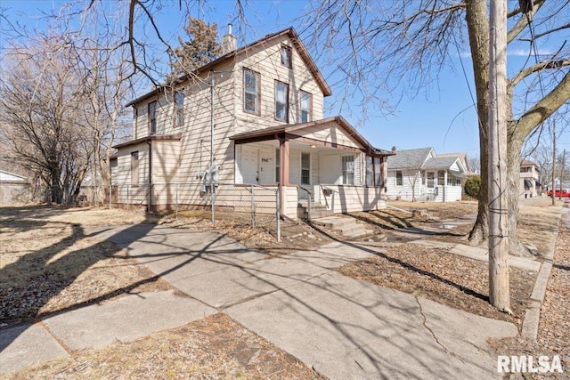 view of front facade featuring covered porch and fence