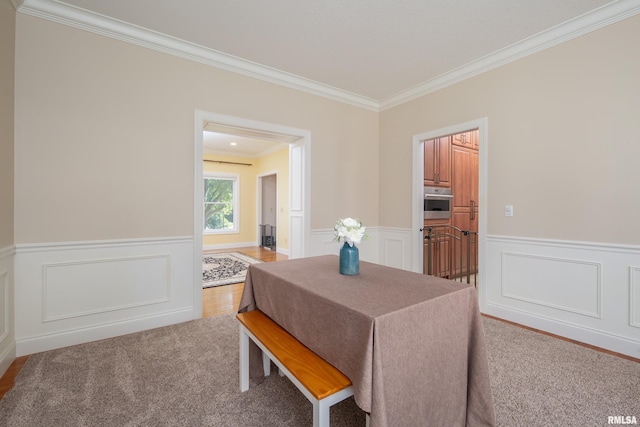 dining area with wood-type flooring and crown molding