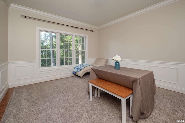 dining space featuring hardwood / wood-style flooring and crown molding