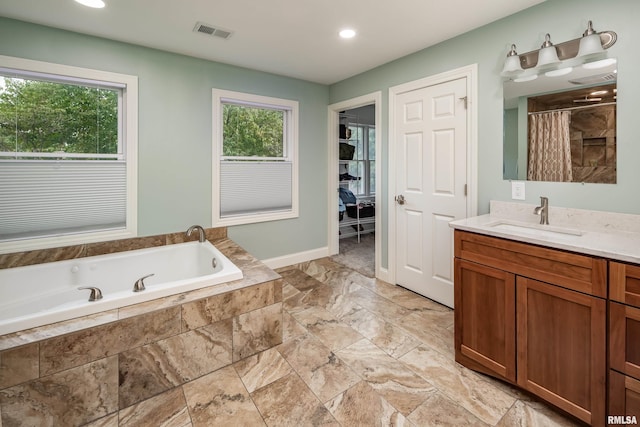 bathroom featuring vanity and separate shower and tub