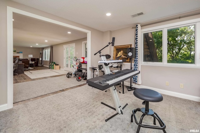 workout room with light colored carpet