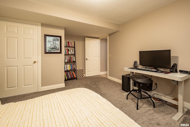 bedroom featuring a textured ceiling and carpet floors