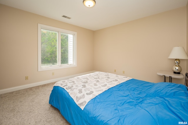 bedroom featuring light colored carpet