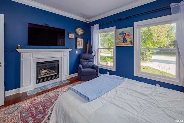 bedroom with crown molding and dark wood-type flooring