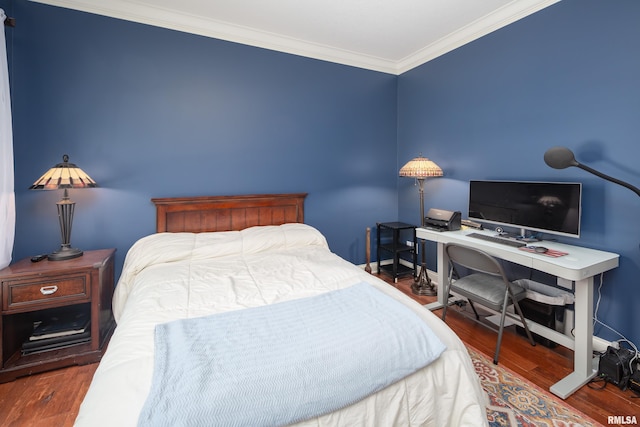 bedroom with dark wood-type flooring and ornamental molding