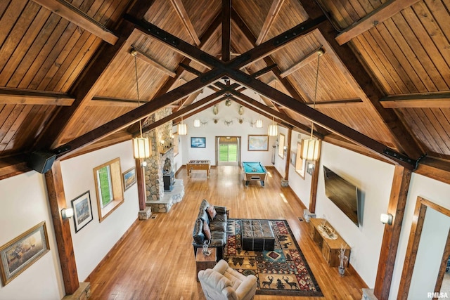 unfurnished living room with beamed ceiling, hardwood / wood-style floors, and wooden ceiling