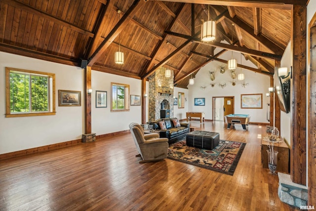 living room featuring beamed ceiling, wood-type flooring, high vaulted ceiling, and wooden ceiling