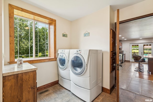 laundry area featuring washer and dryer and a wealth of natural light