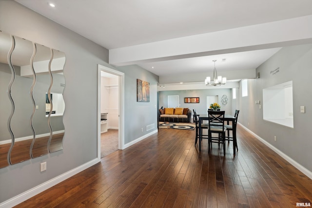 dining room featuring dark hardwood / wood-style floors and a notable chandelier