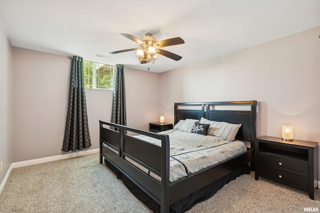 bedroom with ceiling fan and light colored carpet