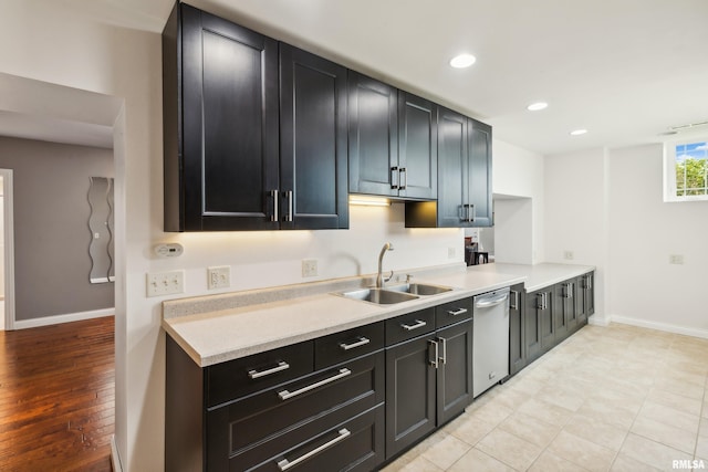 kitchen featuring sink, light tile patterned floors, and stainless steel dishwasher