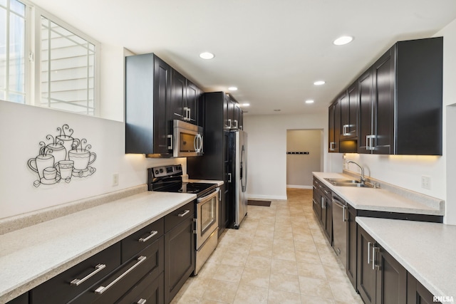 kitchen with sink, light tile patterned floors, and appliances with stainless steel finishes