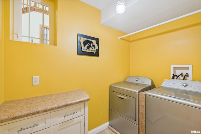 washroom with cabinets and independent washer and dryer