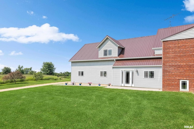 back of house featuring a yard and a patio area