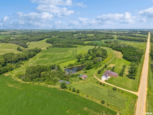 birds eye view of property with a water view and a rural view