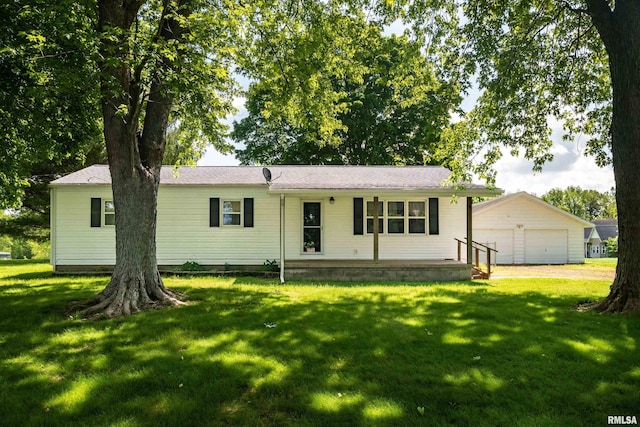 ranch-style house featuring a garage, a porch, an outbuilding, and a front lawn