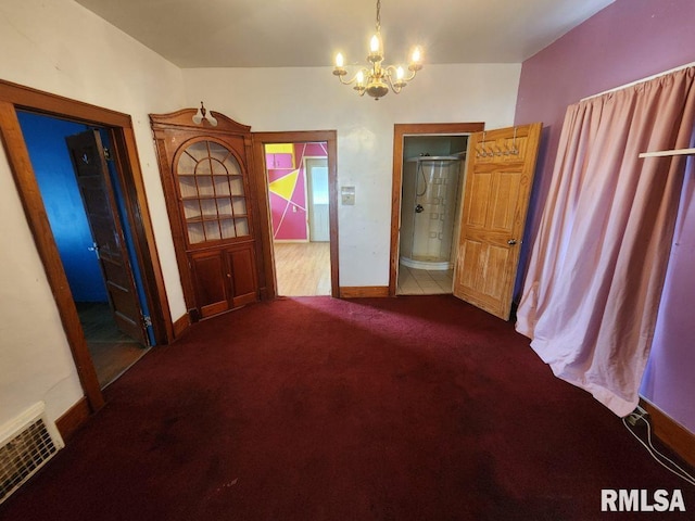 interior space with carpet floors and a notable chandelier