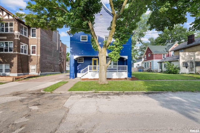 view of front of house with a front yard and covered porch