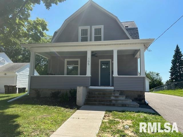 bungalow-style house featuring covered porch, a garage, and a front yard