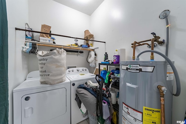 clothes washing area with water heater and washer and dryer