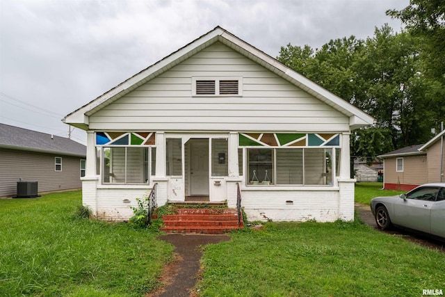 view of front facade with central AC unit and a front lawn