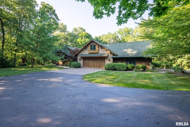 view of front of house featuring a garage and a front lawn