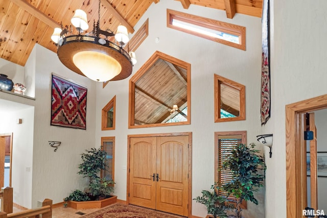 entryway with high vaulted ceiling and beamed ceiling