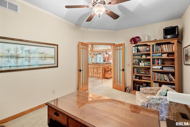 office featuring french doors, ceiling fan, and light colored carpet