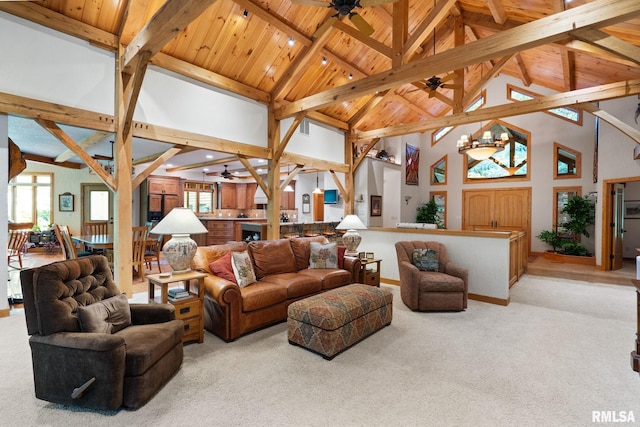 living room with ceiling fan with notable chandelier, light carpet, and high vaulted ceiling