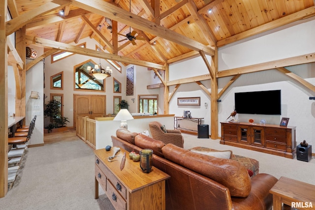 carpeted living room with ceiling fan with notable chandelier, beamed ceiling, wood ceiling, and high vaulted ceiling