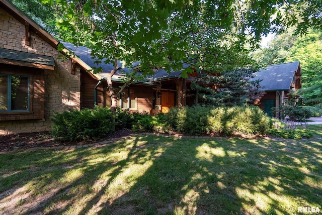 view of side of property with a lawn