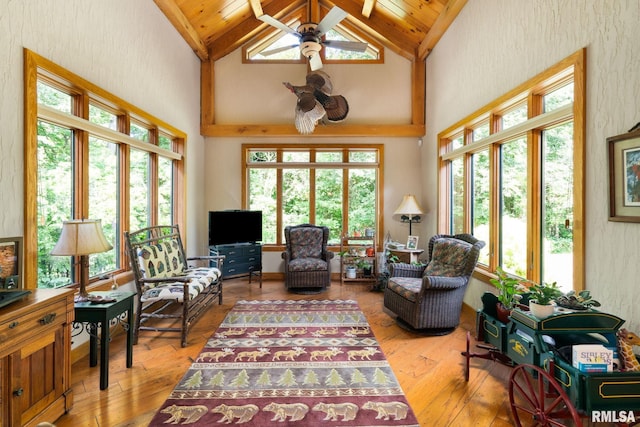 interior space featuring light hardwood / wood-style floors, wooden ceiling, ceiling fan, and plenty of natural light