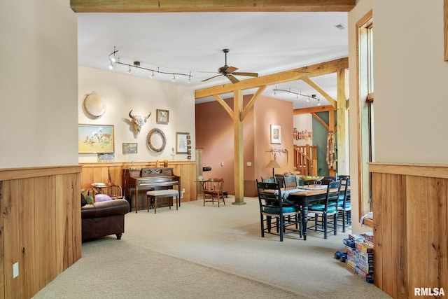 interior space featuring beam ceiling, rail lighting, and ceiling fan