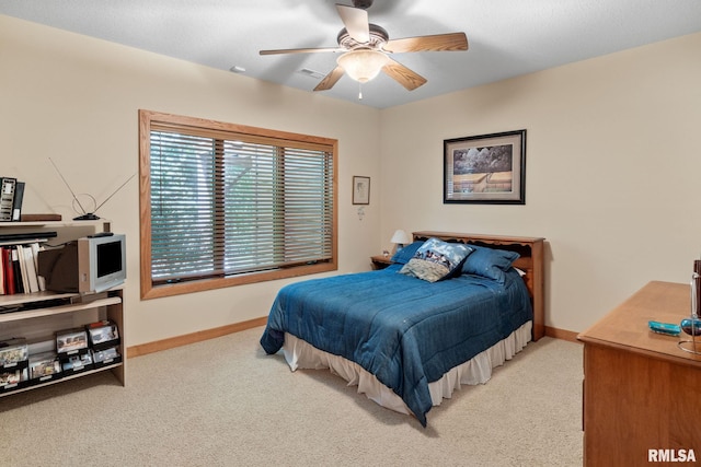 bedroom with light carpet and ceiling fan