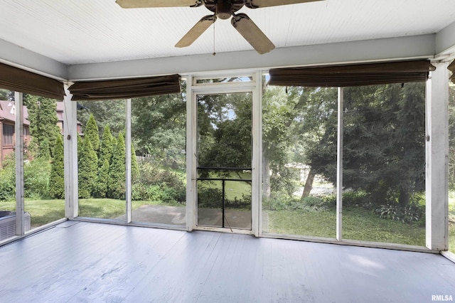 unfurnished sunroom featuring ceiling fan