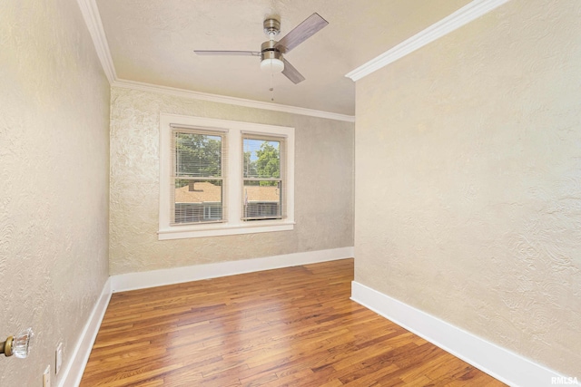 unfurnished room featuring crown molding, hardwood / wood-style floors, and ceiling fan