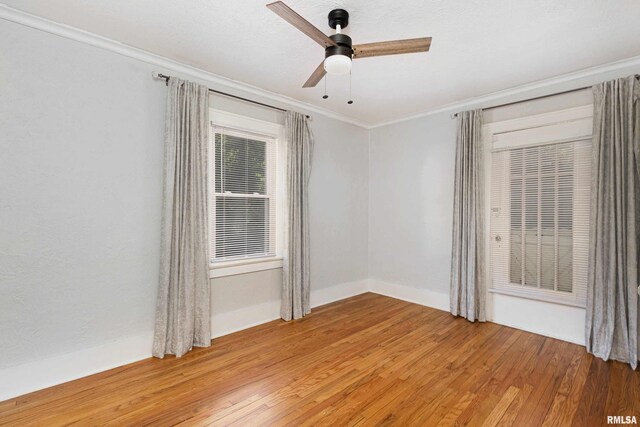 spare room featuring crown molding, ceiling fan, and hardwood / wood-style floors