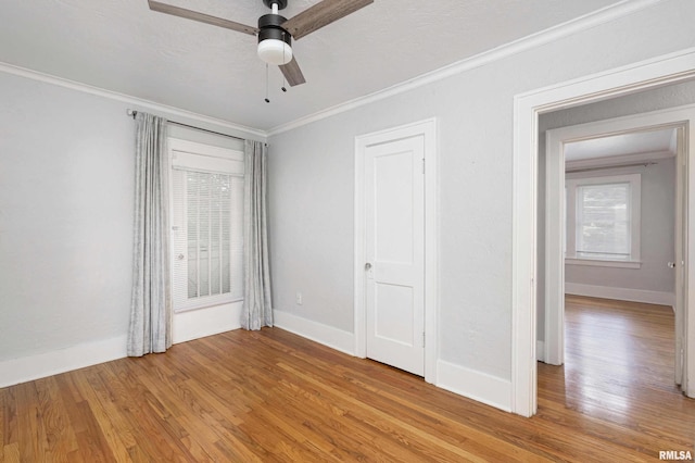 unfurnished bedroom featuring ornamental molding, hardwood / wood-style floors, and ceiling fan