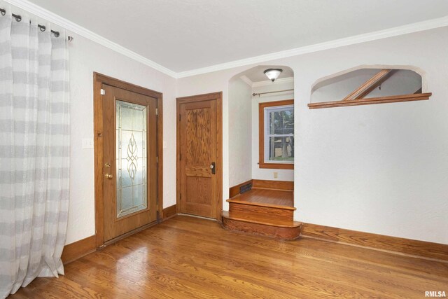 entrance foyer with wood-type flooring and ornamental molding